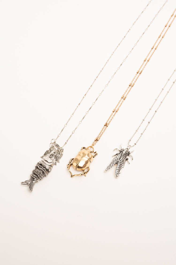 Set of three golden and silver Beetle pendant necklaces