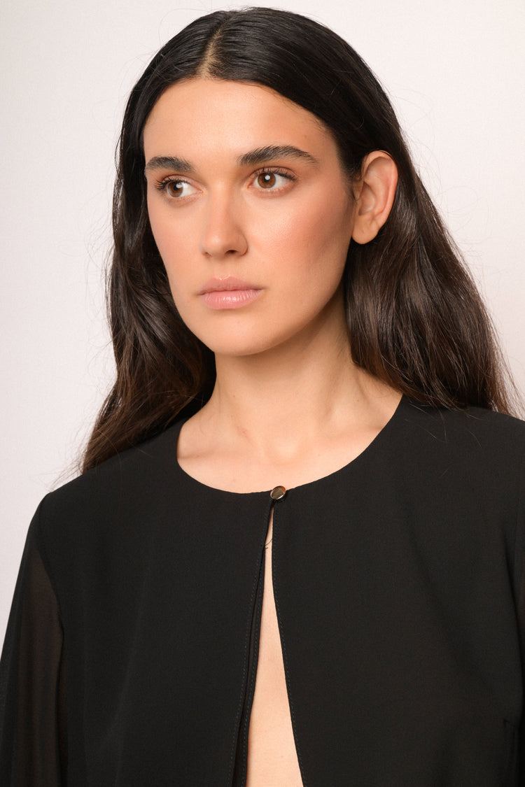 Black shrug with button and cape sleeves