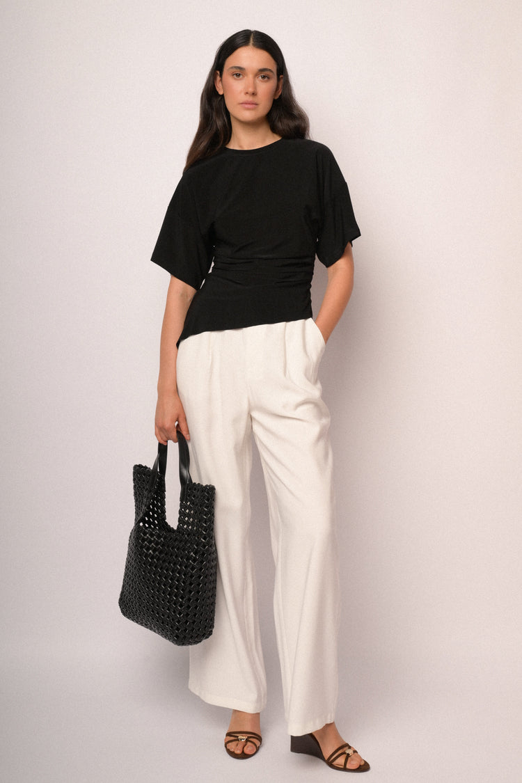 Black top with gathered detail and asymmetric hem