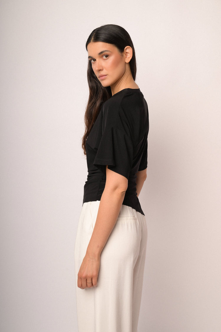 Black top with gathered detail and asymmetric hem