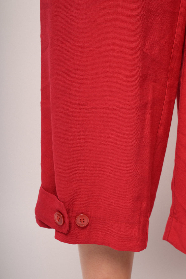Red cropped trousers with hem buttons