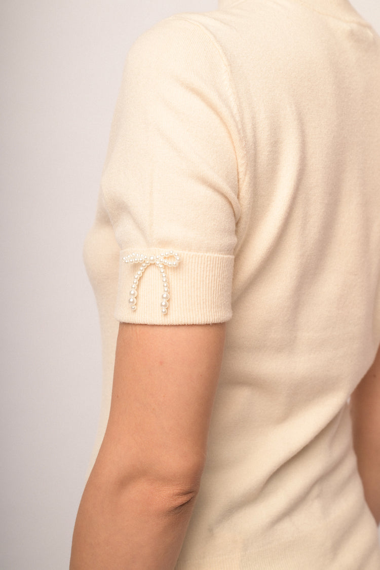 Maglia con fiocco perline manica