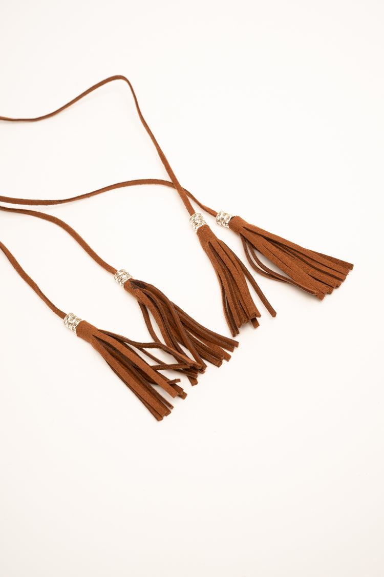Fringed tassels and floral motif tan faux suede slim belt