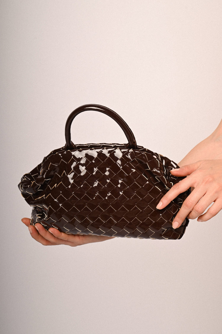 Woven motif faux patent leather handbag