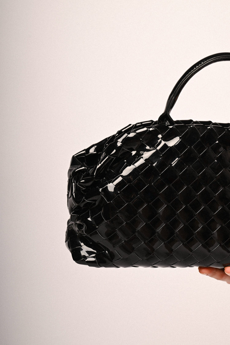 Black woven faux patent leather handbag