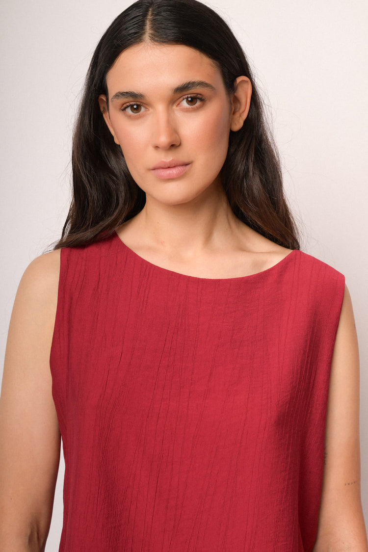 Red sleeveless top with boat neckline