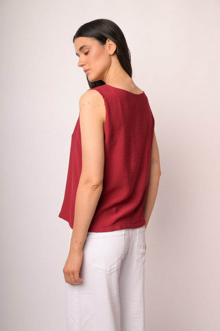 Red sleeveless top with boat neckline
